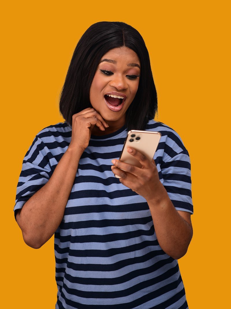 A woman smiling at her phone